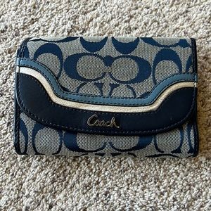 A blue Coach wallet. Medium in size.